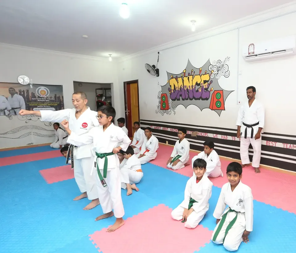Children practising techniques together on the mat