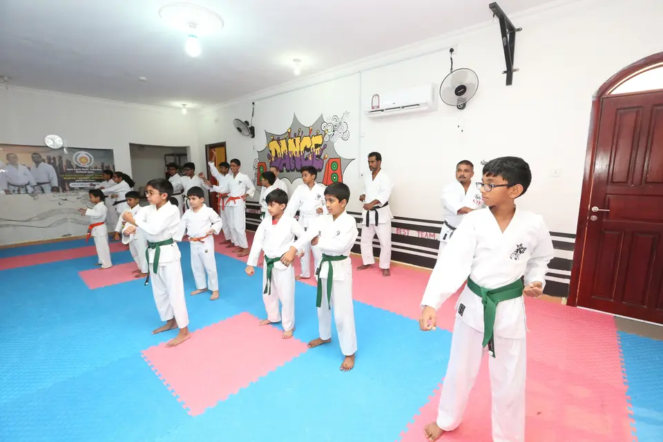 Green-belt students in a karate stance