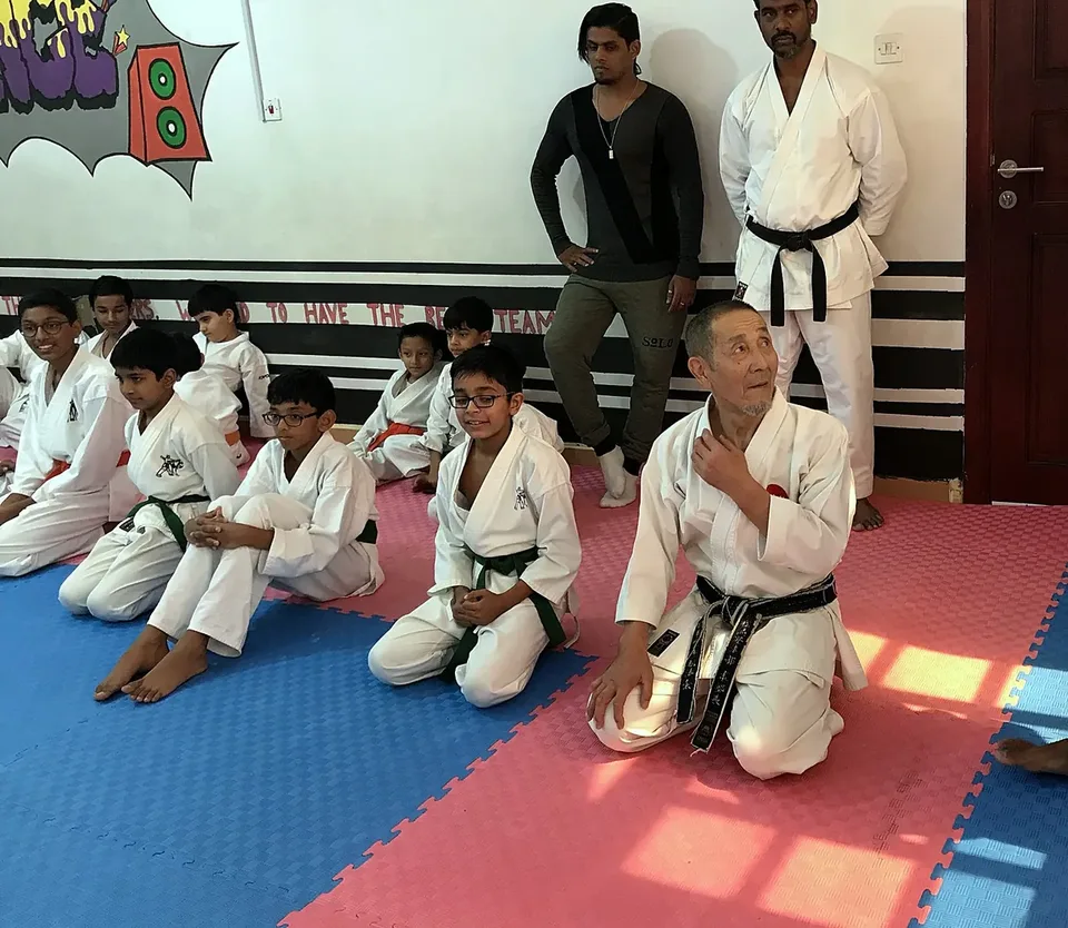 A visiting master teaching Chi Club students at a karate seminar in Doha